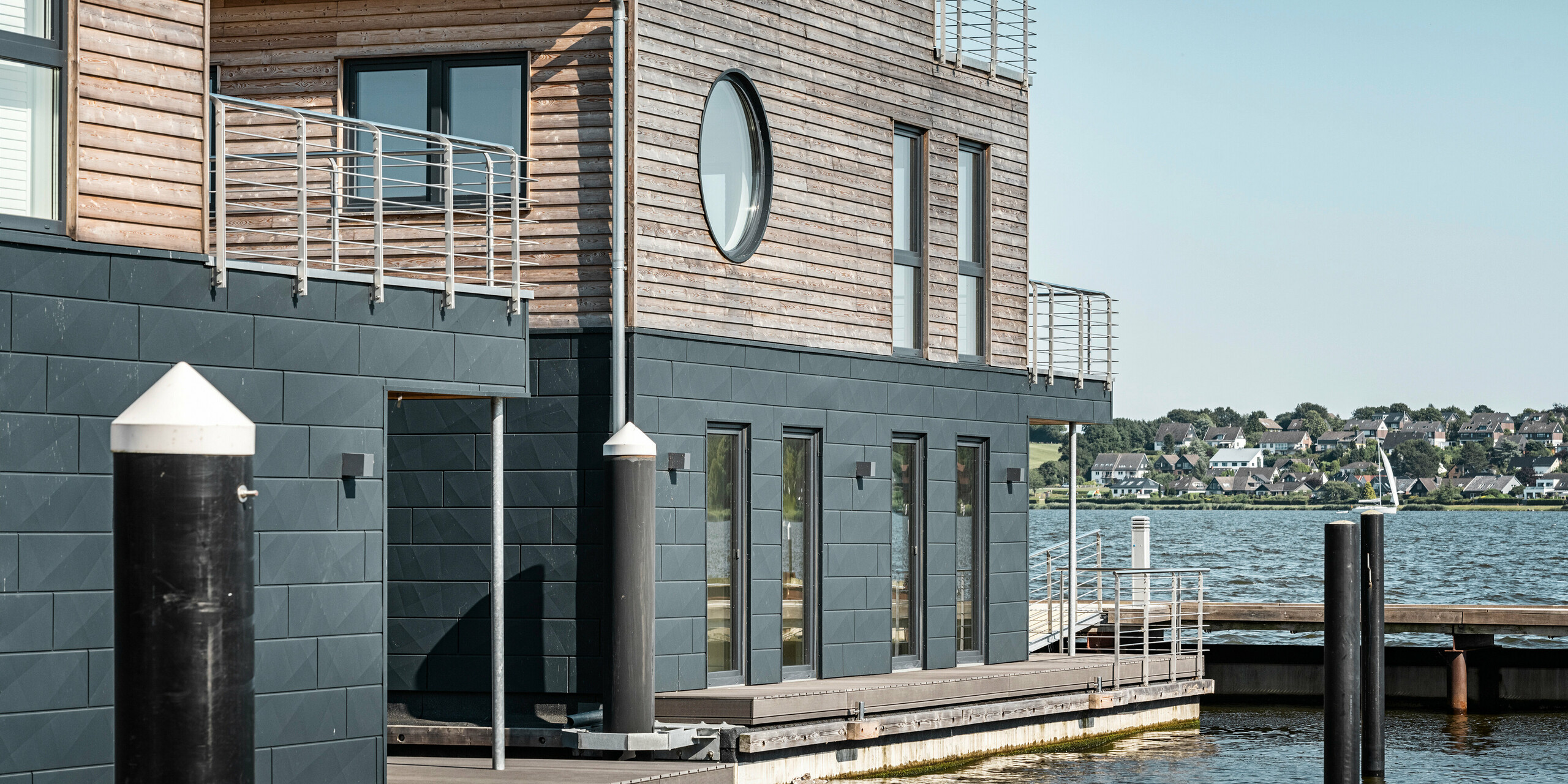 La façade en aluminium Siding.X PREFA entoure onze maisons flottantes dans le port pionnier du Schleswig.