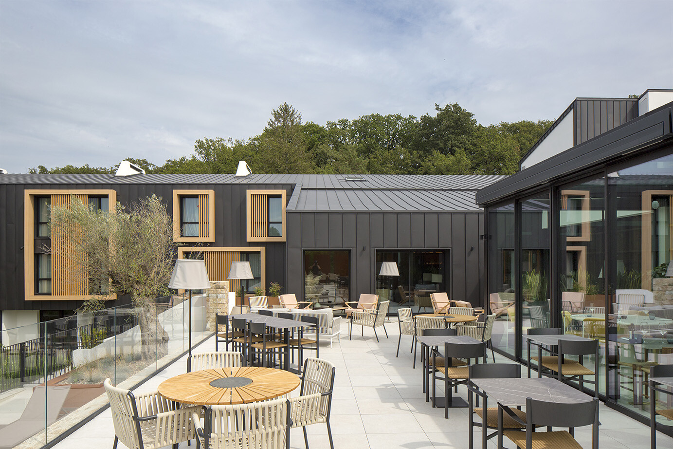 Prise de vue depuis la terrasse du restaurant de l'Hôtel Le Landreau, dont la façade a récemment été rénové en aluminium PREFA