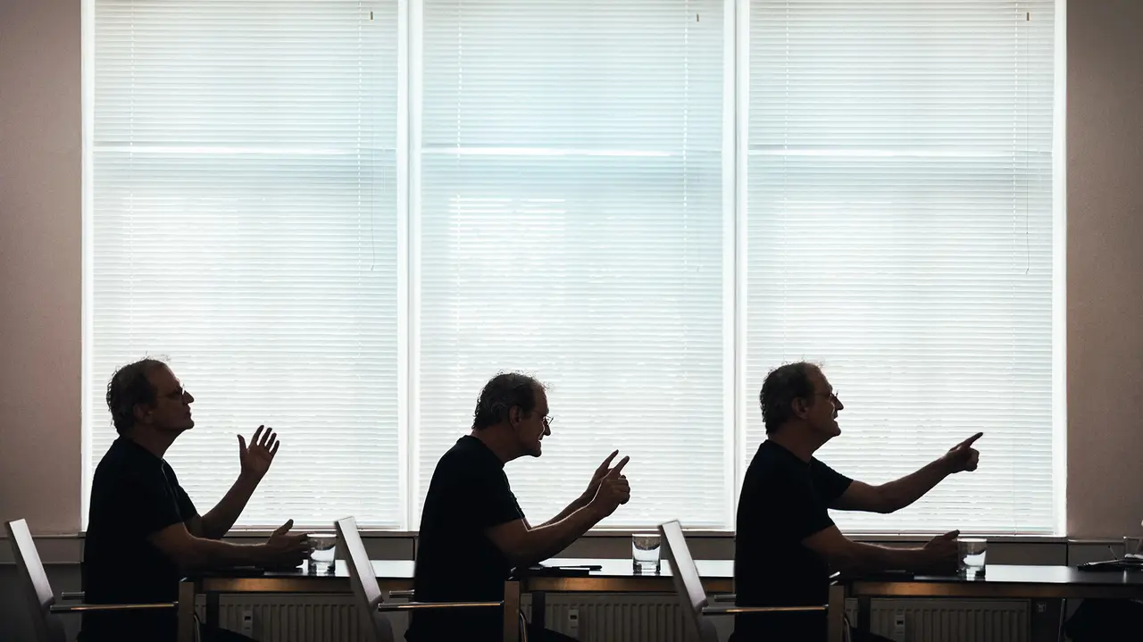 Trois vues de profil de l'architecte Anton Mariacher, le regard tourné vers la droite, faisant différents gestes.