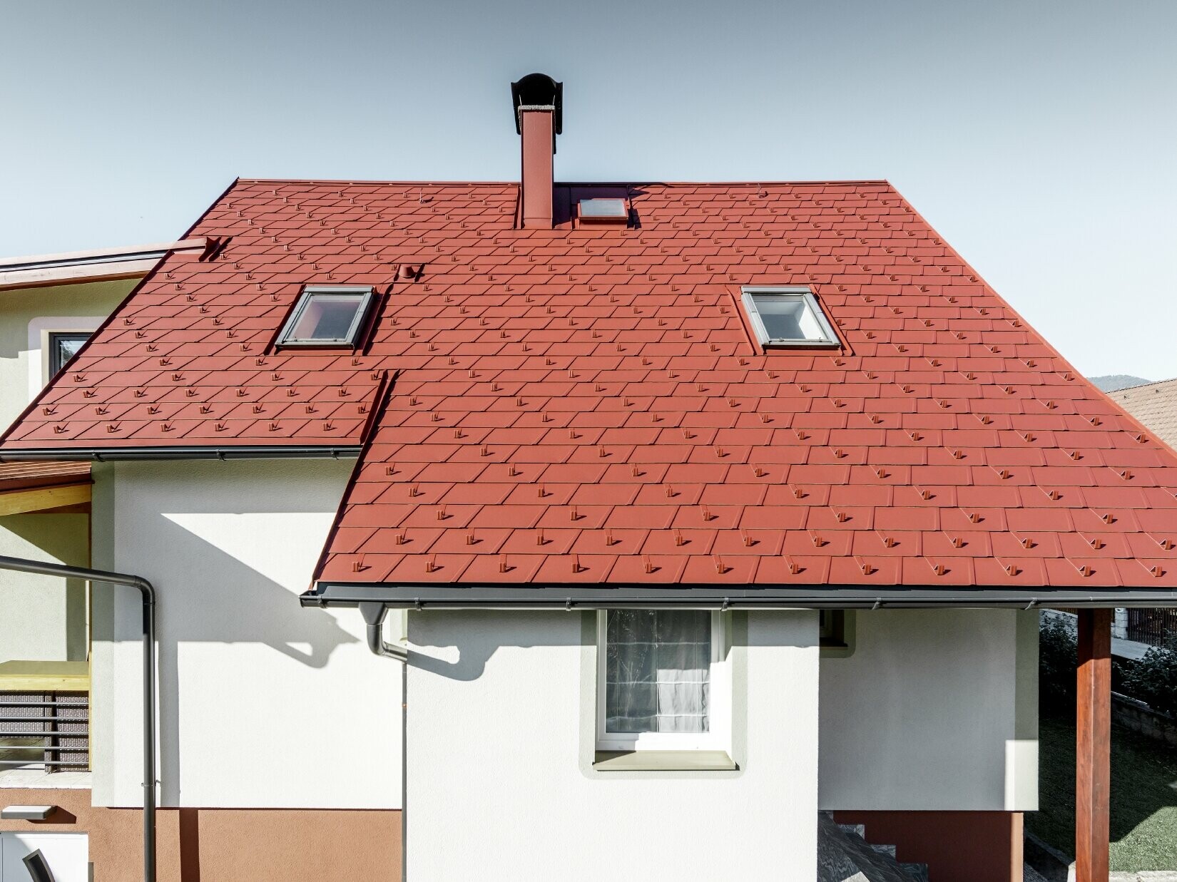 Maison individuelle rénovée avec toiture couverte de bardeaux de toiture PREFA. Le choix s’est porté sur le DS.19 de couleur rouge oxyde.