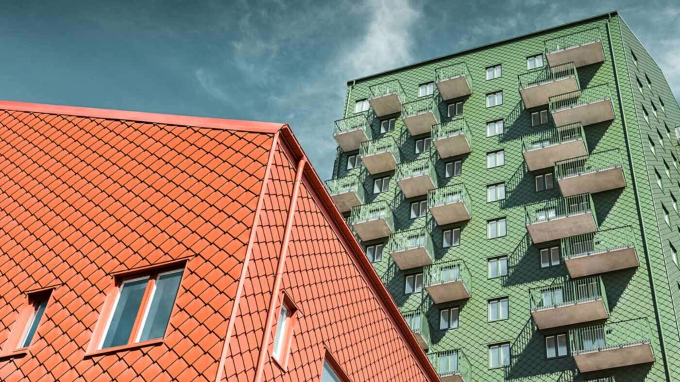 Habitations suédoises avec balcons et losanges de façade PREFA de couleur vert et rouge tuile.