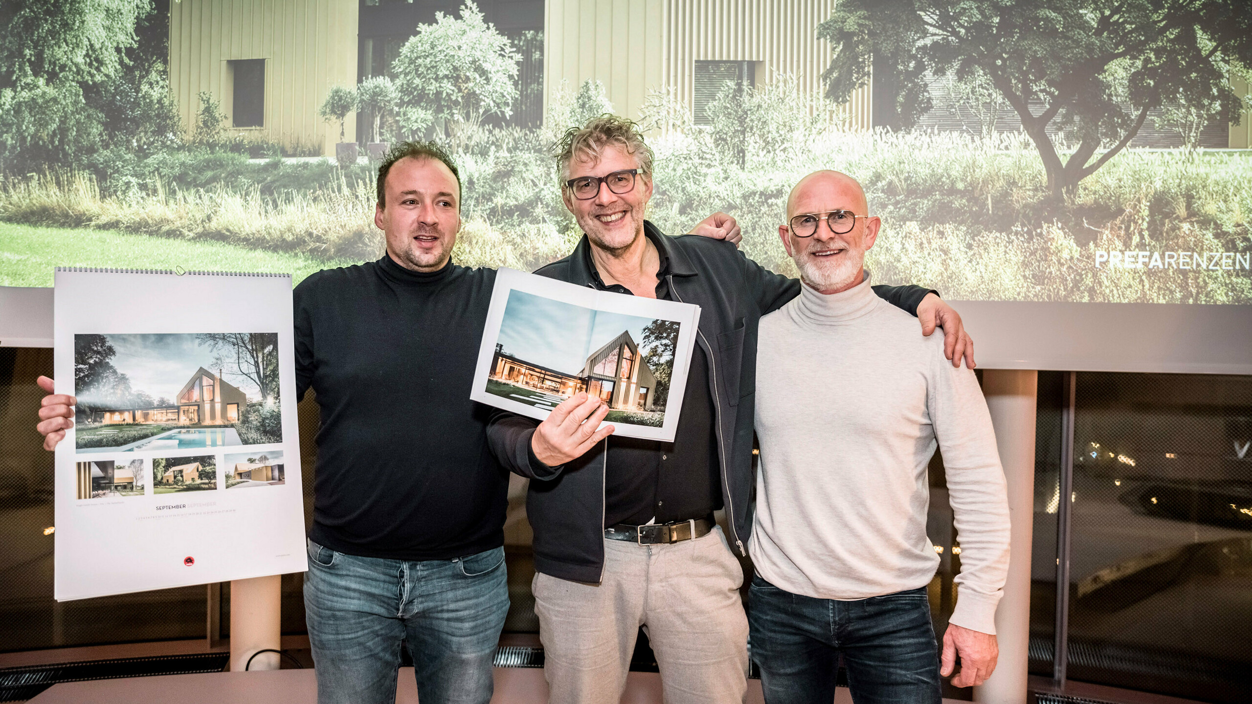 L'artisan Johan Duinkerke avec le calendrier en main, l'architecte Kees Marcelis qui tient le livre, Henk Smienk.