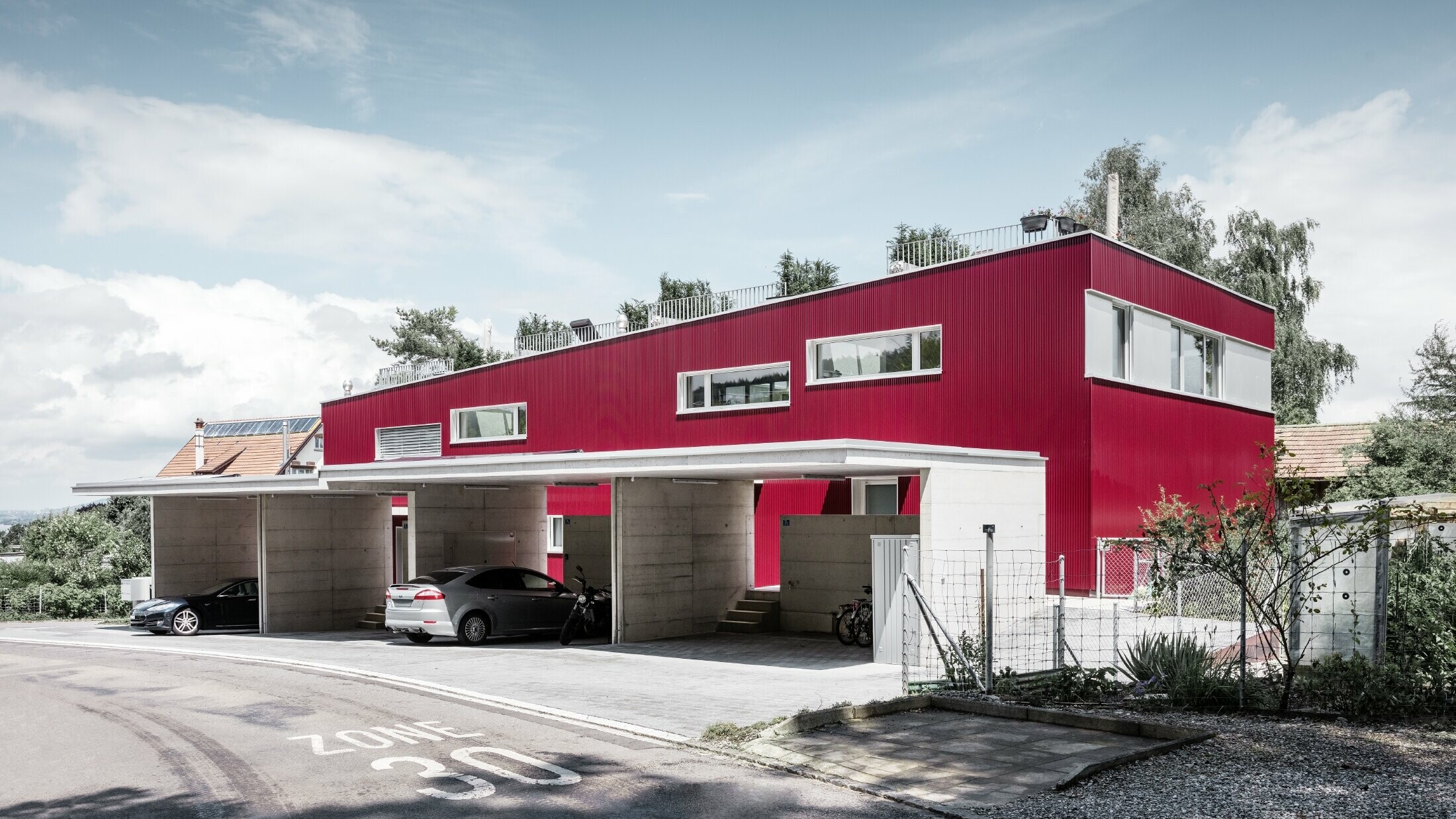 Une splendide façade rouge dotée de profils sinus PREFA orne les nouvelles habitations