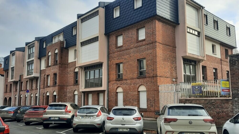 Vue latérale d'un immeuble situé à Arras dont la toiture a été rénovée en FX.12 et bardeaux PREFA