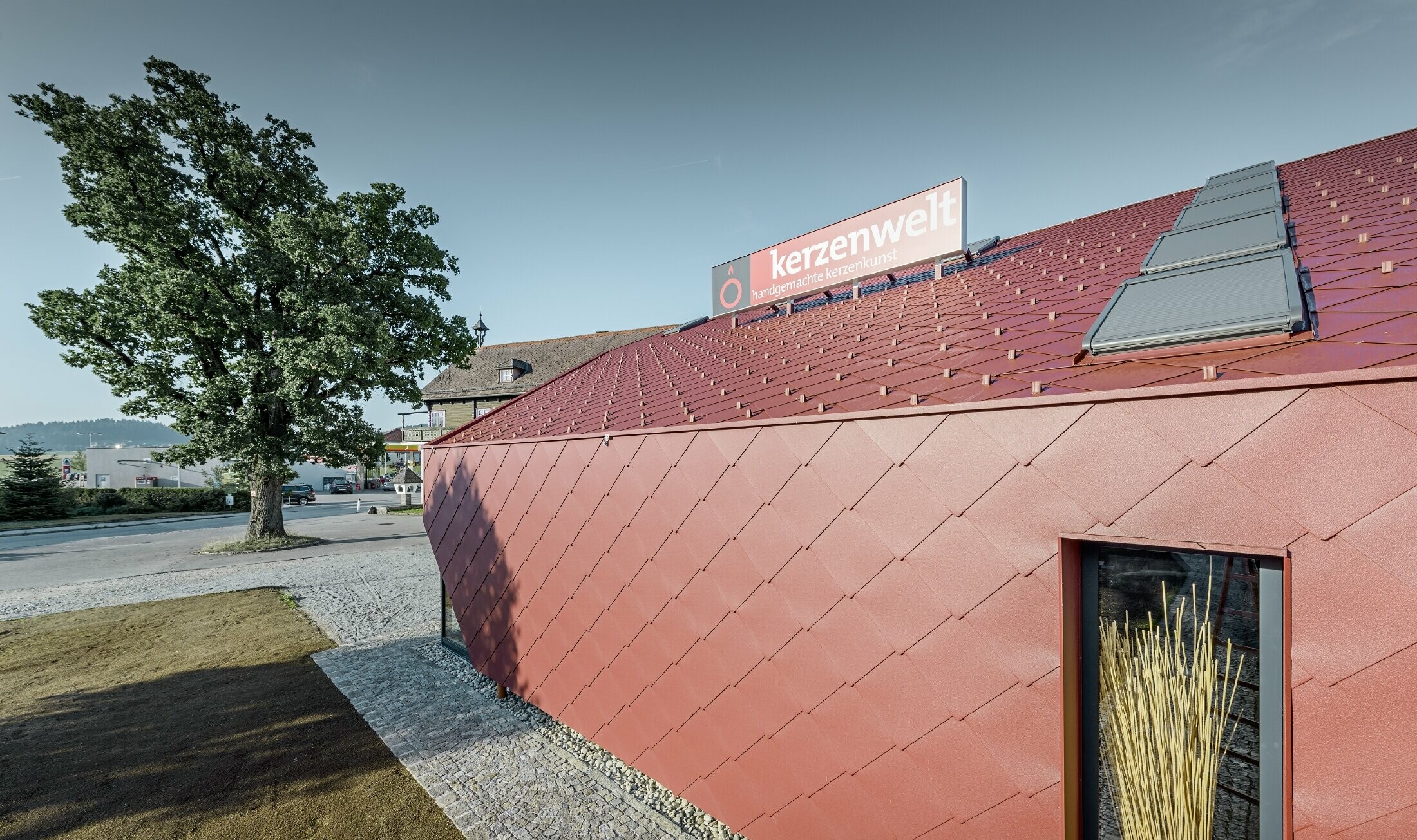 Le Kerzenwelt de Schlägl a été entièrement habillé de losanges PREFA. La couverture de toit et l’habillage de façade ont été réalisés avec le losange 44 × 44 couleur rouge oxyde.